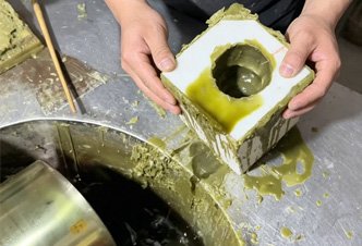 Master artisan preparing a precision wax mold during the traditional lost-wax casting process to achieve museum-quality detail and 99% likeness for custom bronze statues