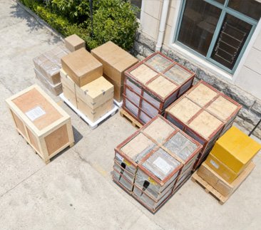 Securely packed bronze statues in export crates at the foundry illustrating factory-direct pricing advantage without middleman markups