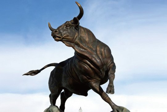 Finished monumental bronze charging bull statue with realistic muscle texture for outdoor business plaza landmark