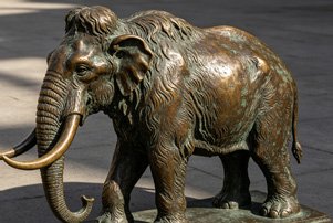 Large-scale bronze mammoth sculpture with museum-quality replication, illustrating our Prehistoric & Extinct Animals collection for theme parks.