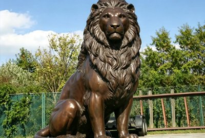 Majestic bronze lion statue for a luxury hotel entrance, providing a prestigious and sophisticated visual focal point for hospitality spaces