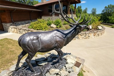 Artistic bronze stag sculpture used in commercial complex landscaping to create visual highlights and increase property value.