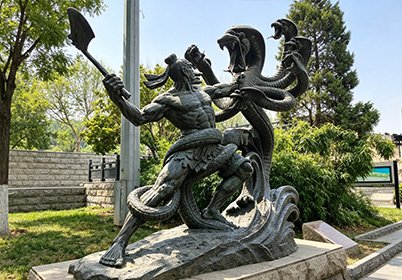 Bespoke monumental bronze sculpture of a mythological hero battling snakes, showcasing high-fidelity lost-wax casting and 1:1 clay model precision