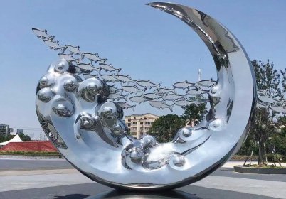 Contemporary mirror-polished stainless steel moon sculpture featuring specialized wind-load structural design for modern hotel landscapes