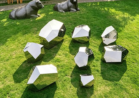 Modern abstract Custom Stainless Steel Sculptures with high-gloss mirror polishing on a lawn, designed as landscape focal points for developers and architects.