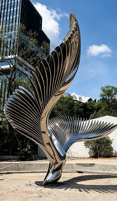 Monumental stainless steel abstract wing sculpture installation, illustrating why Wensculp is highly in the commercial and real estate sector , including Residential Developers and Hotel Lobbies .