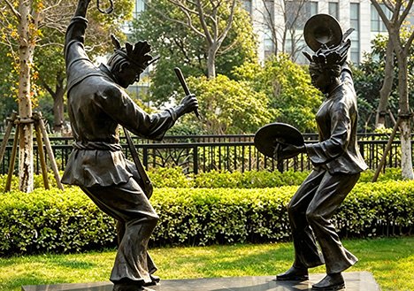 Custom Bronze Sculptures of traditional figures installed at a luxury residential entrance, designed to elevate prestige for sales gallery lobbies and property developments.