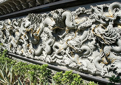 Intricate high-relief dragon Custom Stone Sculptures for residential landscape walls and office building facades, designed to minimize O&M costs for property management.