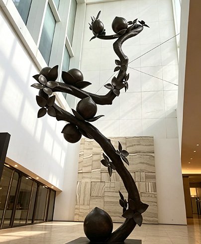 An elegant custom bronze tree sculpture in a luxury hotel Lobby and Entrance, demonstrating Wensculp's Hotels & Hospitality Sculpture Applications for high-end interior spaces.