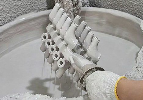Industrial-scale silica sol dipping process for sculpture molds, illustrating our Stable High-Volume Production Capacity with standardized fabrication and +/-1mm dimensional tolerances.