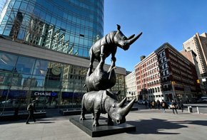Large-scale interactive rhinoceros bronze sculpture in a public space, serving as a high-traction social media landmark for theme parks and tourism destinations