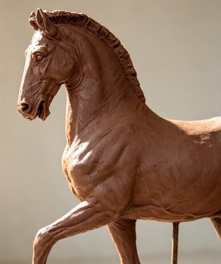 A highly detailed clay horse sculpture showcasing Anatomical Precision & Dynamic Vitality , emphasizing The Critical Importance of Precision Clay Modeling for 1:1 Full-Scale Replication .