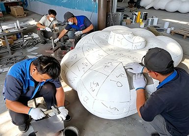 Wensculp artisans performing 1:1 scale prototype verification at the direct factory to ensure design fidelity for custom sculpture commissions.