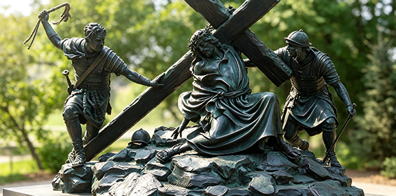 Custom bronze Jesus statue carrying the cross for church outdoor installation