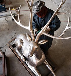 A bronze sculpture is being polished at the factory.
