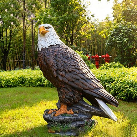 realistic fiberglass bald eagle statue in a garden