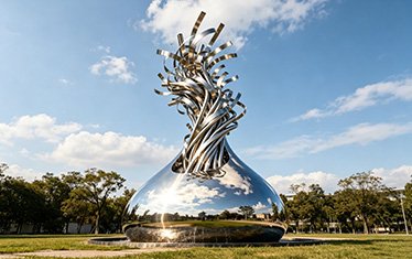 Organic fluid stainless steel sculpture in a public park