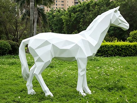 white low-poly geometric fiberglass horse statue on grass