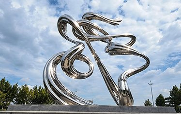 Kinetic wind-driven stainless steel sculpture outdoors