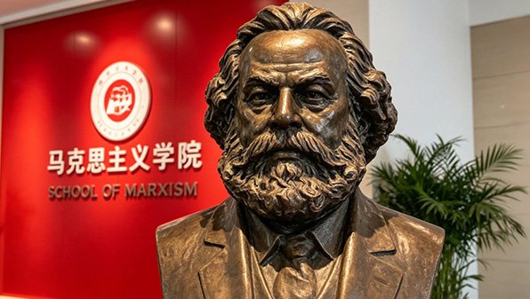 Detailed bronze portrait bust of Karl Marx displayed at a school of Marxism, sculpted from historical photographs