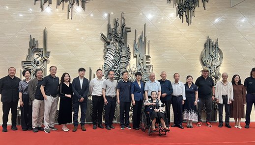 Team and guests at the unveiling of a bronze relief wall by Wensculp Sculpture